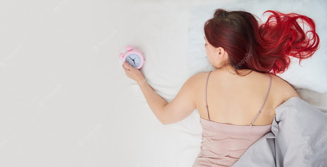 a lady wear sleepwear or pajamas sleep on bed